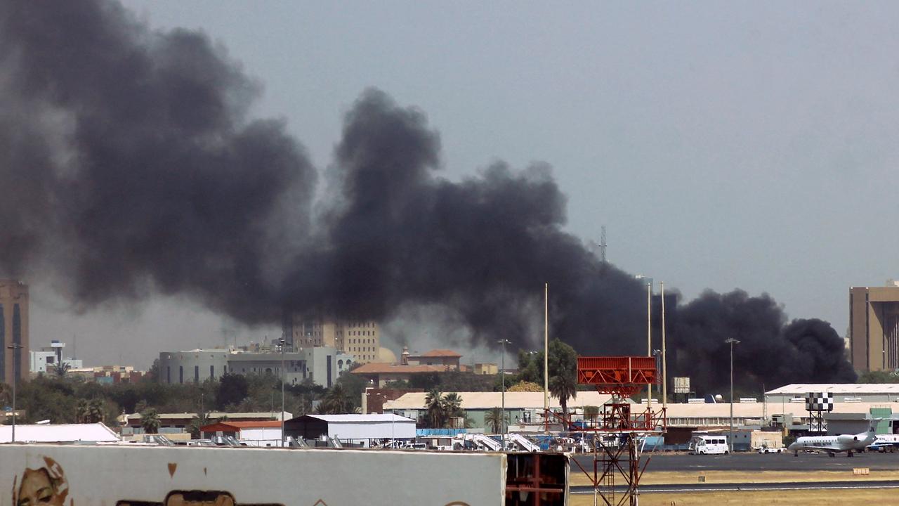 Heavy smoke billows above buildings near Khartoum Airport. Picture: AFP