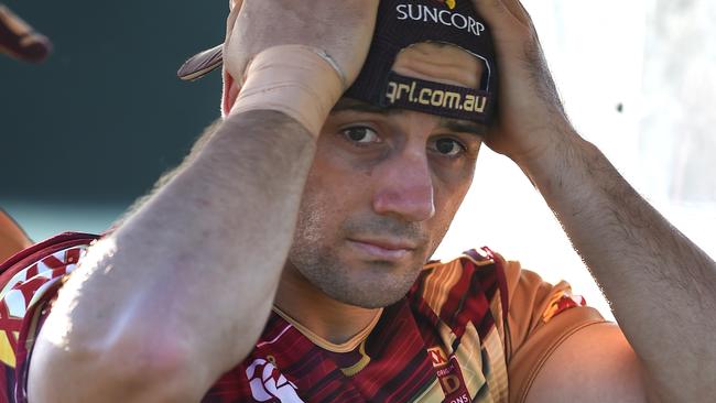 Cooper Cronk is driven away for treatment after sustaining an ankle injury during the Maroons Origin team training session at Sanctuary Cove on the Gold Coast on Friday.