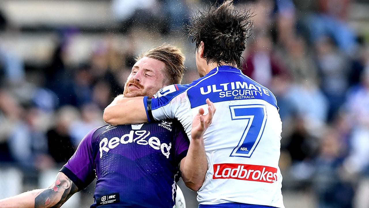Cameron Munster of the Storm is hit high in the tackle by Lachlan Lewis.
