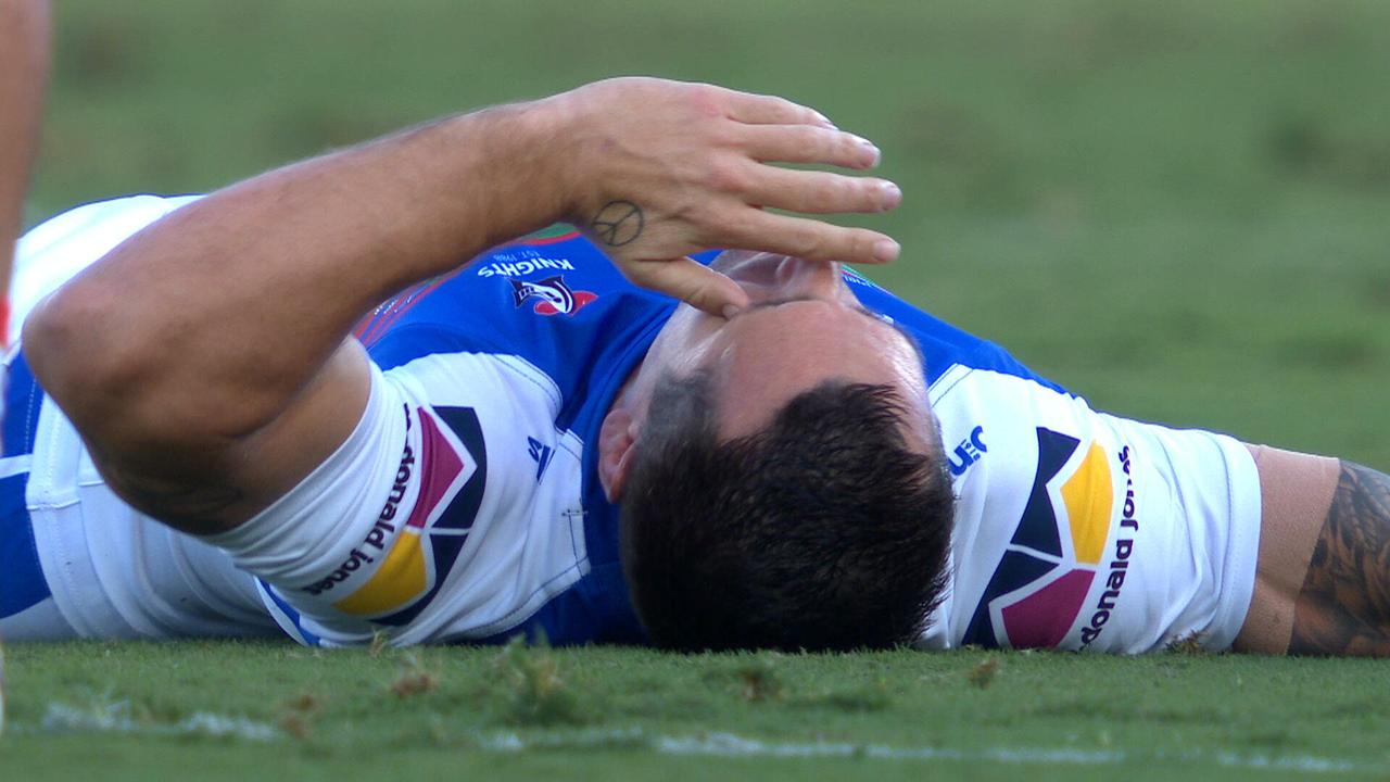Mitchell Pearce lays on the ground after being knocked out in a tackle.