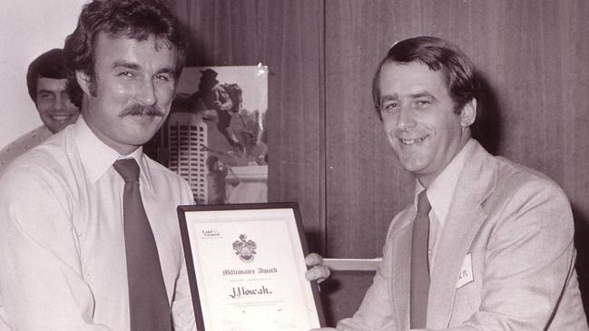 A young Joe Nowak (left) receiving an award from a Legal &amp; General executive in 1975.