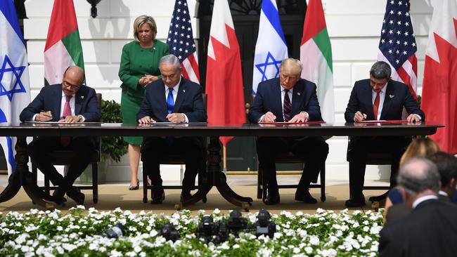 Bahrain Foreign Minister Abdullatif al-Zayani, Israeli Prime Minister Benjamin Netanyahu, US President Donald Trump, and UAE Foreign Minister Abdullah bin Zayed Al-Nahyan sign the Abraham Accords.