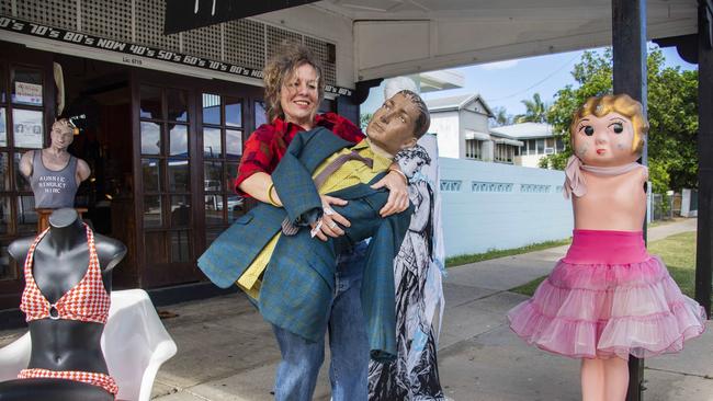 Megan Card, who has been operating Crackerbox Palace in Cairns for almost 30 years, arranges mannequins on the footpath outside her shop. Picture: Brian Cassey