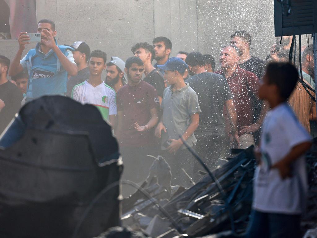 Palestinians gather at the scene of a strike in the central Gaza Strip on November 4, 2023, amid ongoing battles between Israel and the militant group Hamas. Picture: AFP.