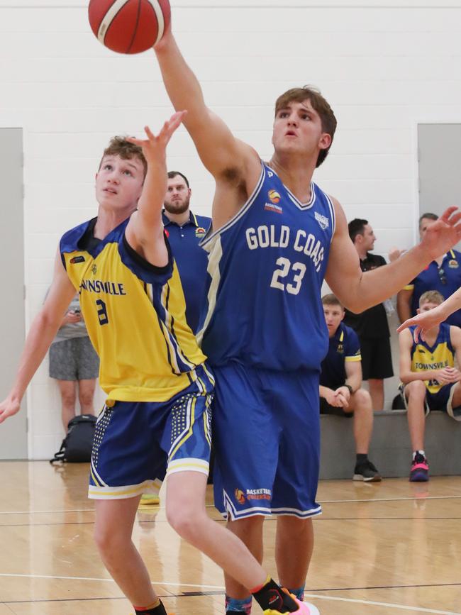 Basketball Queensland Under-16 Boys State Championships at the Coomera Indoor Sports Centre. Gold Coast Rollers (blue) v Townsville Heat Division 1 game . Rollers Nikos Karathanasopoulos (23) and Heats Jack Abbott (8) Picture Glenn Hampson