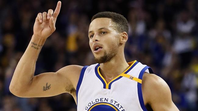 Stephen Curry #30 of the Golden State Warriors reacts after making a three-point basket.