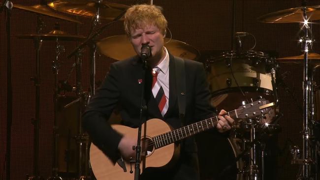 Ed Sheeran plays a newly written song, Visiting Hours at Michael Gudinski's state memorial service.