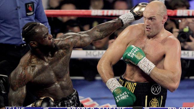 Tyson Fury, right, and Deontay Wilder trade punches during their WBC heavyweight title fight at the MGM Grand in Las Vegas last February. Picture: AFP