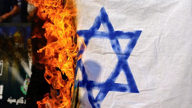 Demonstrators burn a homemade Israeli flag following the assassination of Lebanon's Hezbollah leader Sheikh Hassan Nasrallah, during a protest rally in the front of Israeli Consulate in Istanbul on September 29, 2024. People protested in Istanbul after the Iran-backed group Hezbollah party confirmed on September 28, that its longtime chief Hassan Nasrallah had been killed by an Israeli air strike on Beirut's southern suburbs on September 27. (Photo by Yasin AKGUL / AFP)