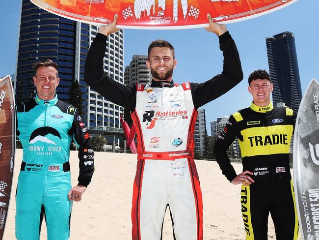 Supercar Championship drivers come together on Surfers Paradise beach to officially kick off race week. Supercars drivers James Courtney, Andre Heimgartner and Declan Fraser, show off the 2023 Boost Mobile GC500 trophies four days before their cars hit the race track. Picture Glenn Hampson