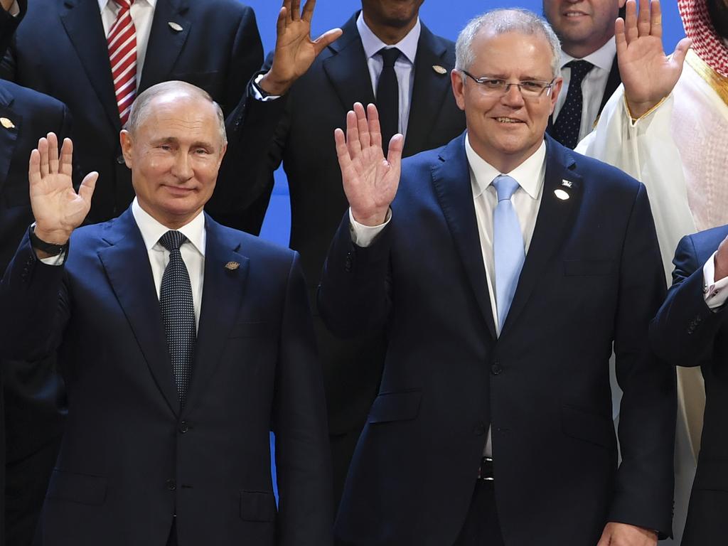 Prime Minister Scott Morrison and Russian President Vladimir Putin wave during the so-called “family picture” at the G20 summit in Buenos Aires, Argentina, in 2018. Picture: AAP Image/Lukas Coch