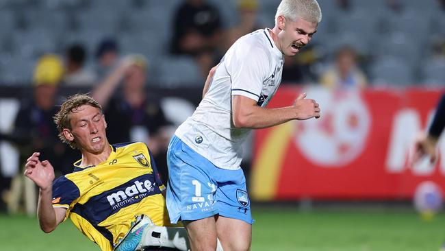 GOSFORD, AUSTRALIA - FEBRUARY 10: Patrick Wood of Sydney FC is tackled by Jacob Farrell of Central Coast during the A-League Men round 16 match between Central Coast Mariners and Sydney FC at Industree Group Stadium, on February 10, 2024, in Gosford, Australia. (Photo by Mark Kolbe/Getty Images)