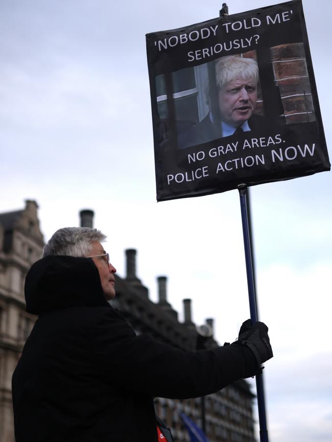 A protester in Parliament Square holds a placard with of Boris Johnson with the words ‘Nobody told me seriously? No gray areas. Police action now’. Picture: Getty Images