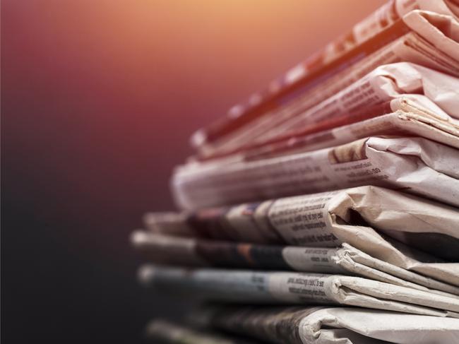 Pile of newspapers on white background