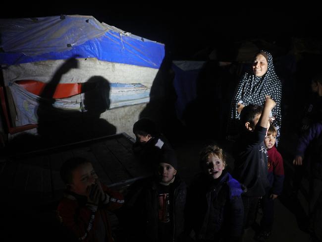 Palestinians celebrate the ceasefire at their camp for people displaced by conflict at Deir el-Balah in the central Gaza Strip. Picture: AFP