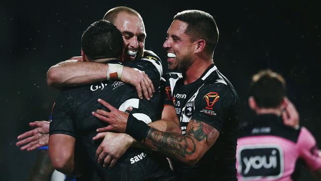 Kodi Nikorima is congratulated by teammates Simon Mannering and Gerard Beale after scoring a try.