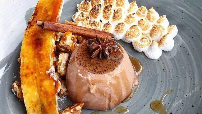 Wild Pear Cafe's Chocolate Chai Pannacotta is served with a brûléed banana, walnut brittle, Italian meringue and maple syrup for $13.90. Picture: Wild Pear Cafe