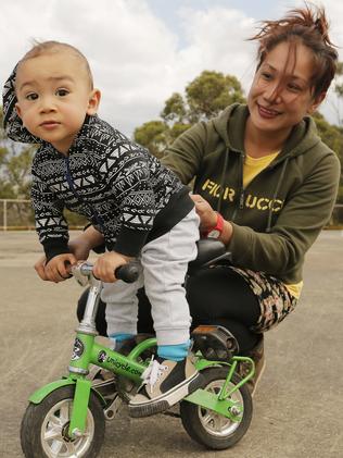 One-year-old Krixus Johnson, with a little help from his mum Jozzie Johnson, finds Psychles’ tiny bike a pretty good fit.  Picture: MATHEW FARRELL