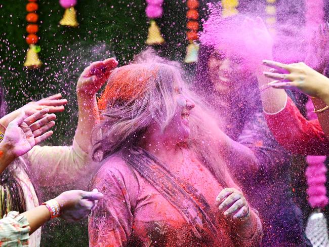 TOPSHOT - Women smeared with âGulal' as they celebrate Holi, the Hindu spring festival of colours, in Chennai on March 25, 2024. (Photo by R.Satish BABU / AFP)