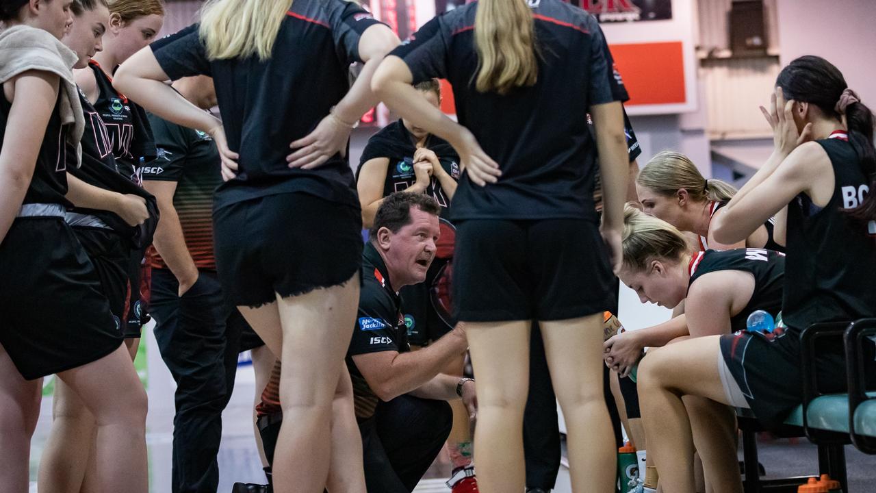 Scott Mckenzie (middle, crouched) has been appointed the Mackay Meteorettes 2021 NBL1 North coach after leading the team on an unbeaten ConocoPhillips CQ Cup campaign. Photo: Trudi Jensen