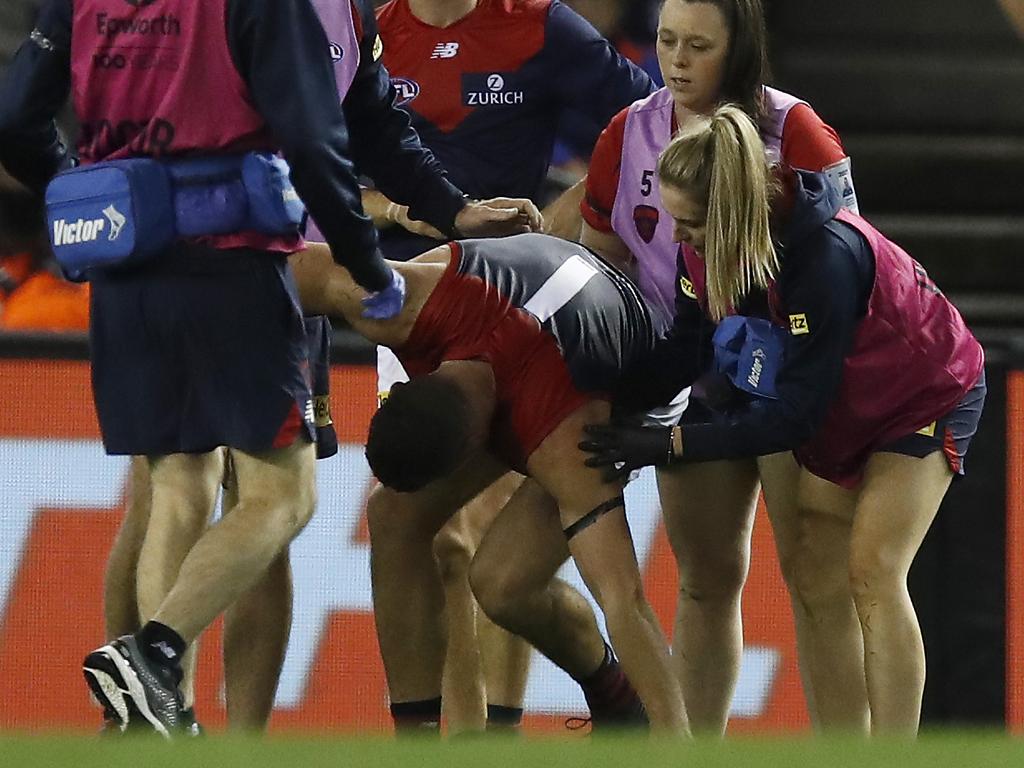 Steven May is helped to his feet by trainers after a heavy hit against the Bulldogs.