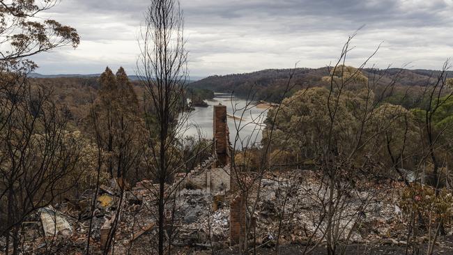 A chimney and part of a staircase are all that remained of a house in Tathra after bushfires destroyed 65 houses, 35 caravans and cabins, and damaged 48 houses. Picture: Brook Mitchell/Getty