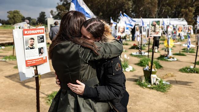 TOPSHOT - Two women react while visiting the site of the Supernova music festival near Kibbutz Reim, southern Israel, on February 19, 2024. Thousands of visitors in Israel have been flocking weekly to the site of the Supernova music festival, to pay their respects to the 364 people killed there by Hamas in the October 7 attacks. The Supernova festival saw the highest toll by far of the sites attacked when Hamas militants broke through from Gaza into southern Israel in an unprecedented attack, which resulted in the deaths of more than 1,160 people. In response, Israel launched a military campaign that has killed at almost 30,000 people in Gaza, mostly women and children, according to the Palestinian territory's health ministry. (Photo by RONALDO SCHEMIDT / AFP) / To go with 'Israel-Palestinians-conflict' by Michael BLUM #MER62