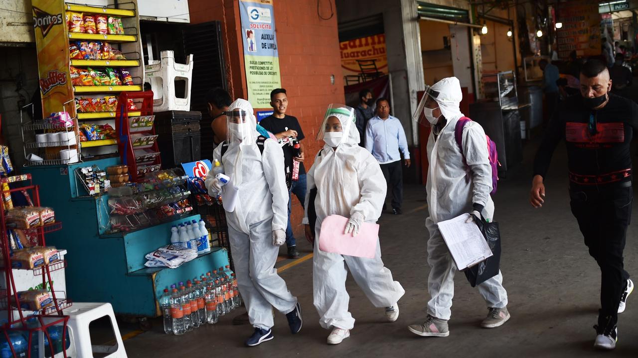 Health workers wearing protective gear walk along the Central de Abastos market in Mexico City on June 10, 2020. Picture: Rodrigo Arangua/AFP