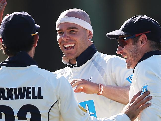 CRICKET - NSW v Victoria at the SCG. Jayde Herrick celebrates with Glenn Maxwell and David Hussey his wicket of Steve Smith.