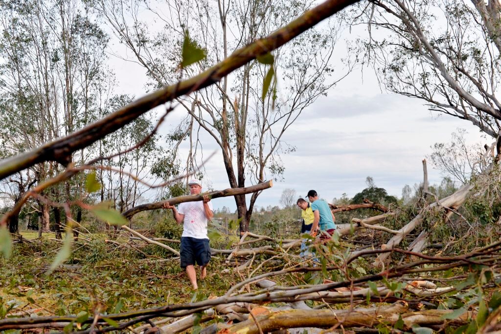 Nick Nixon helping to move a tree aafter the storm in Fermvale. Photo Inga Williams / The Queensland Times. Picture: Inga Williams