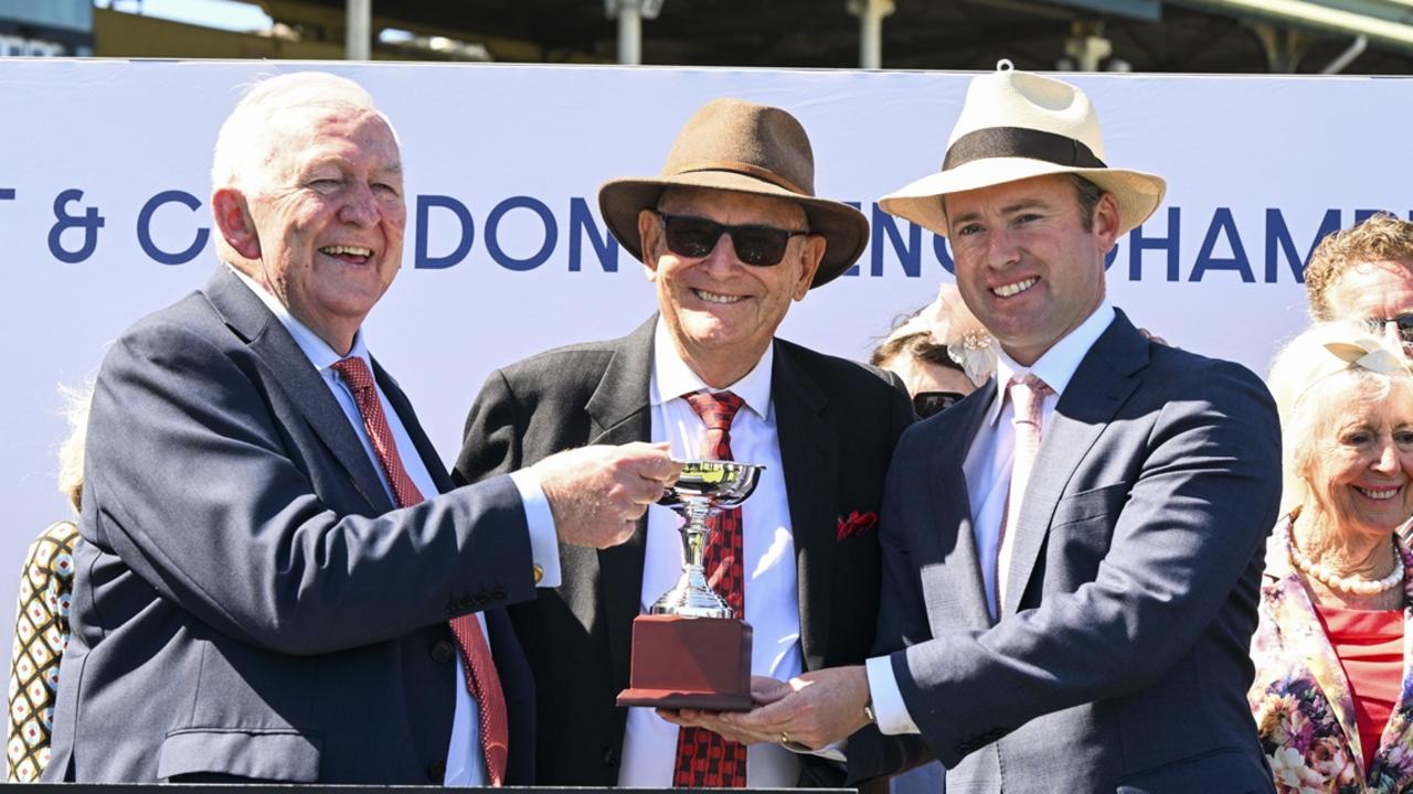 Legendary racing writers Ken Callander (left) and Max Presnell (centre) present the Callander-Presnell trophy to co-trainer Adrian Bott. Picture: Bradley Photos