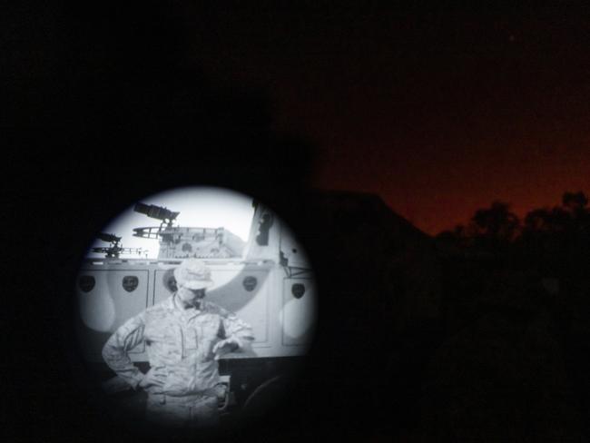 Sergeant Chris Diamond seen checking his watch through infra-red goggles. Picture: Dylan Robinson