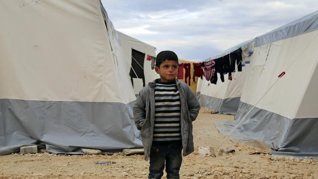 A Syrian boy stands at a temporary refugee camp for displaced Syrians in northern Syria, near Bab al-Salameh border crossing with Turkey, on February 7. Picture: AP