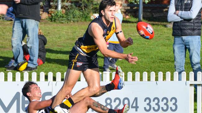 Max Proud dishes out a handball under pressure from Port Adelaide’s Aidyn Johnson in the round eight clash at the Bay. Picture: Brenton Edwards, AAP