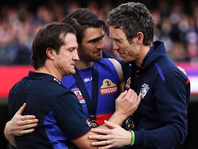 Western Bulldogs coach Luke Beveridge, Captain Easton Wood and Robert Murphy hug on stage after the Bulldogs won the AFL Grand Final between Sydney Swans v Western Bulldogs at the MCG. Picture. Phil Hillyard