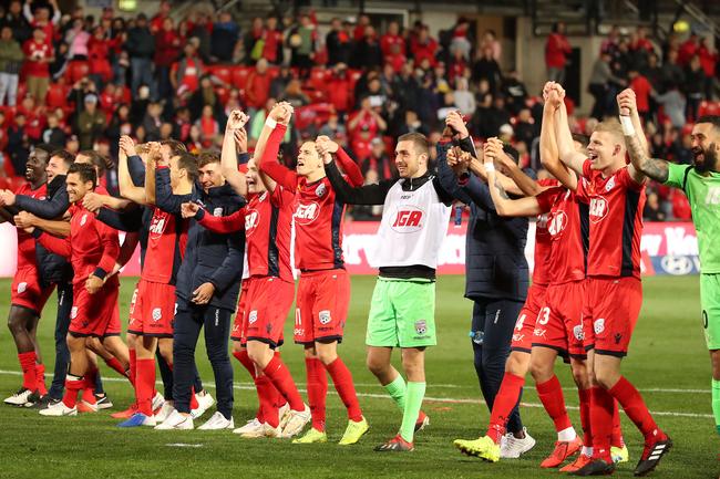 Adelaide United players thank their supporters in the crowd after winning the A-League elimination final at Coopers Stadium,. Picture: Scott Barbour/Getty