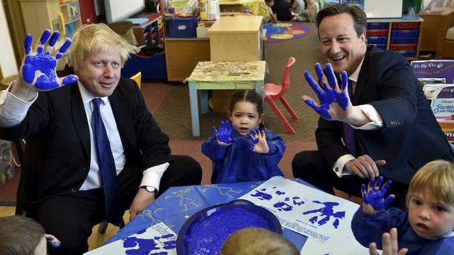 Britain's Prime Minister David Cameron, right, and Mayor of London Boris Johnson take part in a hand painting session.