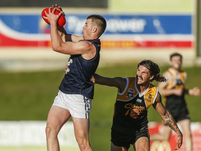 Fletcher Hustwaite takes a grab for Rosebud in front of Frankston YCW’s BJ Credlin. Picture: Valeriu Campan