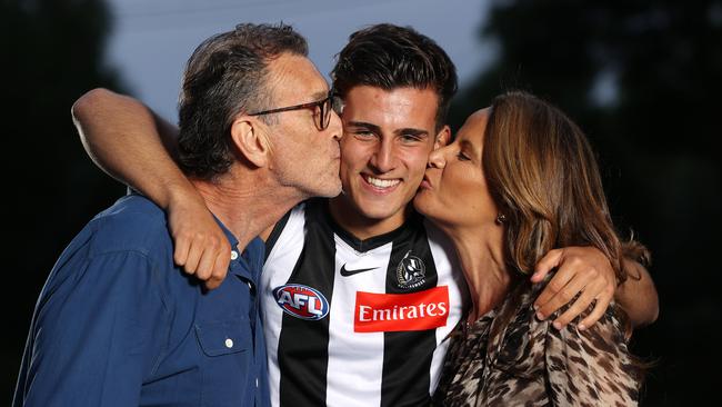 Nick Daicos gets a congratulatory kiss from father Peter and mother Colleen. Picture: Mark Stewart