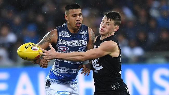 Sam Walsh nudges the ball away from Tim Kelly. Picture: AAP Image/Julian Smith.