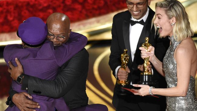 Samuel L. Jackson embraces winner for best adapted screenplay <i>BlacKkKlansman</i>, Spike Lee, as Brie Larson presents the award. Picture: Chris Pizzello/Invision/AP