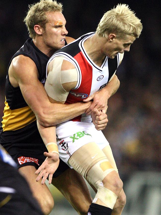 Tiger Luke McGuane curtails Nick Riewoldt ... much to Max Gawn’s pleasure. 