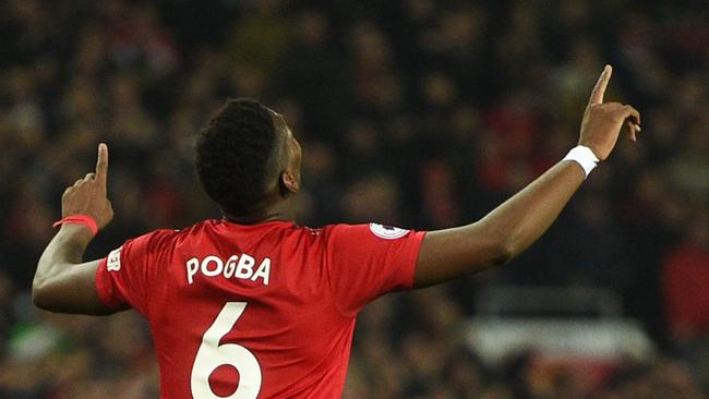 Manchester United's French midfielder Paul Pogba celebrates scoring their second goal during the English Premier League football match between Manchester United and Huddersfield Town at Old Trafford in Manchester, north west England, on December 26, 2018. (Photo by Oli SCARFF / AFP) / RESTRICTED TO EDITORIAL USE. No use with unauthorized audio, video, data, fixture lists, club/league logos or 'live' services. Online in-match use limited to 120 images. An additional 40 images may be used in extra time. No video emulation. Social media in-match use limited to 120 images. An additional 40 images may be used in extra time. No use in betting publications, games or single club/league/player publications. /