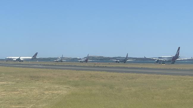 Planes on the runway waiting to take off.