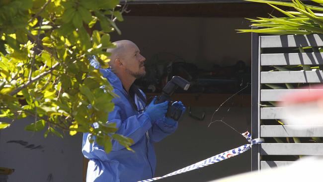 An investigator at the Coomera home.