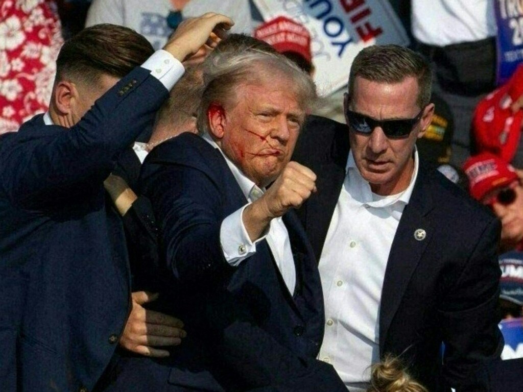 Donald Trump is escorted off a stage in Pennsylvania by US Secret Service agents following an attempted assassination on his life. Picture: AFP