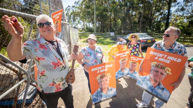 Prime Minister Scott Morrison is heckled by protesters dressed in Hawaiian shirts outside a canning factory in the seat of Gilmore on Monday. Picture: Jason Edwards
