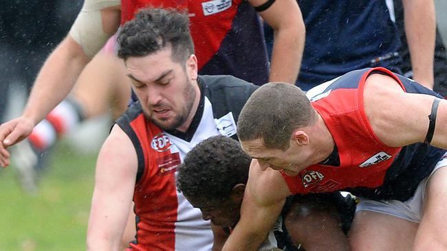 (L-R) West Coburg's Angelos Sidhom and Tullamarine's Michael Egan and Tom Delaney. EDFL Football: West Coburg V Tullamarine at Shore Reserve, Coburg. Picture: Josie Hayden