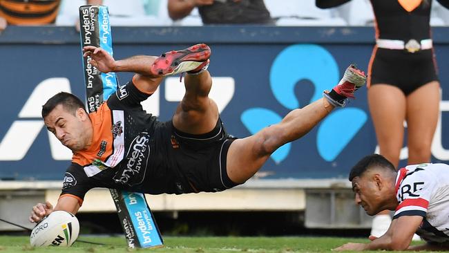 Tigers winger Corey Thompson scores the matchwinning try against the Roosters.