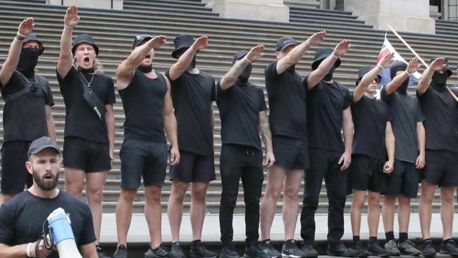 Neo-Nazis hold a Nazi salute on the steps of Victorian parliament. White supremacist and convicted criminal Thomas Sewell holds a megaphone. Picture: David Crosling/NCA NewsWire